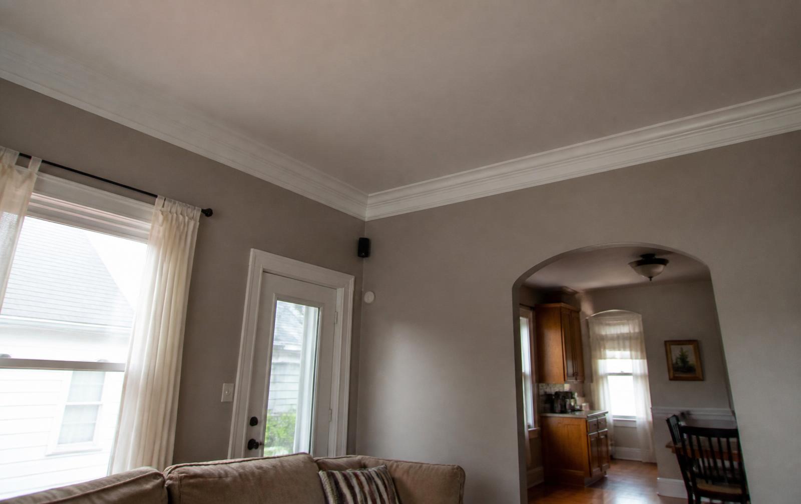 Crown molding along the ceiling line of a Springfield, MO living room with painted white trim